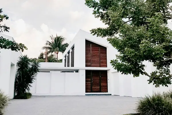 White contemporary building showing the wooden slated entrance