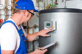 engineer inspecting a boiler